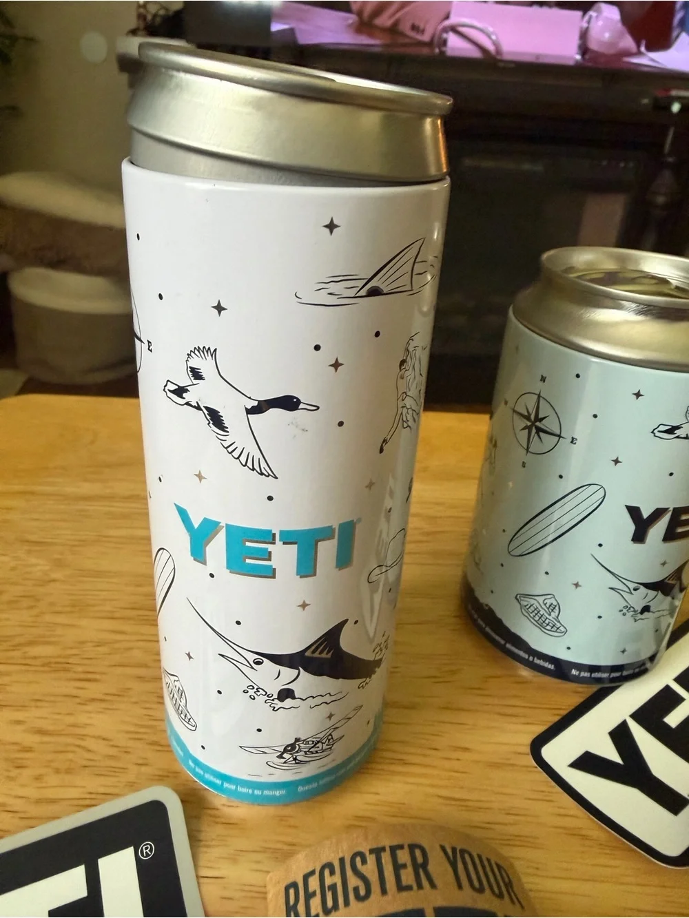 Yeti Slim Can Coolers in Light Gray with Blue Logo Accents